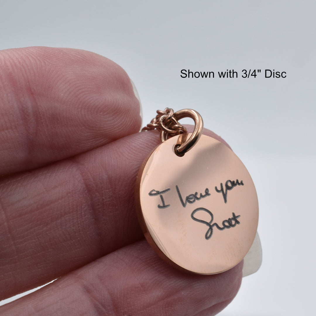 Rose gold pendant with handwritten message 'I love you Shott' held in a hand