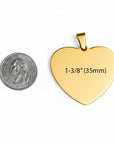 Gold heart-shaped pendant with measurement text next to a quarter for scale on a white background