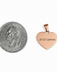 Rose gold heart-shaped pendant next to a quarter for size comparison on a white background