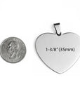 Heart-shaped pendant next to a quarter for size comparison on a white background