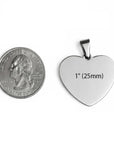 Heart-shaped pendant next to a quarter for size comparison on a white background