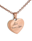A rose gold heart-shaped pendant necklace with the inscription 'Love Mom & Dad'.