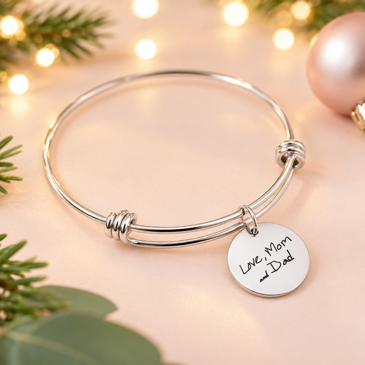 Silver handwriting bracelet on blush background 