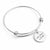 A silver-toned metal expandable wire bangle bracelet with a round engraved disc charm that reads 'Love, Mom and Dad' on a clean white background.