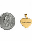 Gold heart-shaped pendant next to a quarter for size comparison on a white background