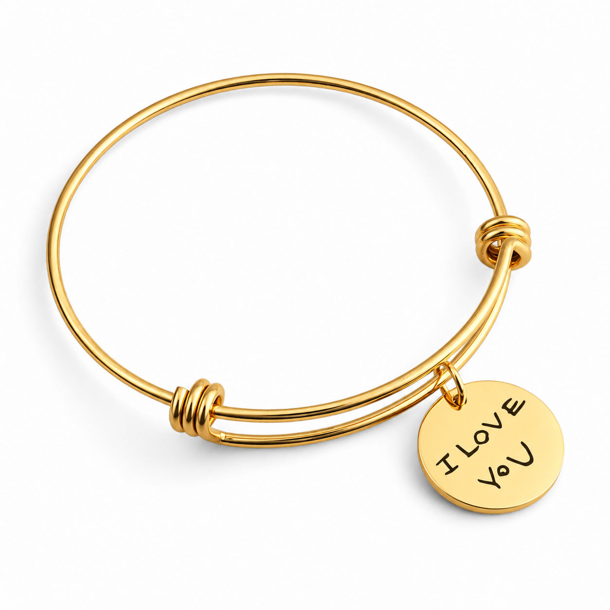 Gold bangle bracelet with a round engraved disc charm that reads 'I LOVE YOU', shown on a clean white background.