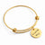 Gold bangle bracelet with a round engraved disc charm that reads 'I LOVE YOU', shown on a clean white background.