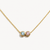 Gold necklace with two gemstones on a white background