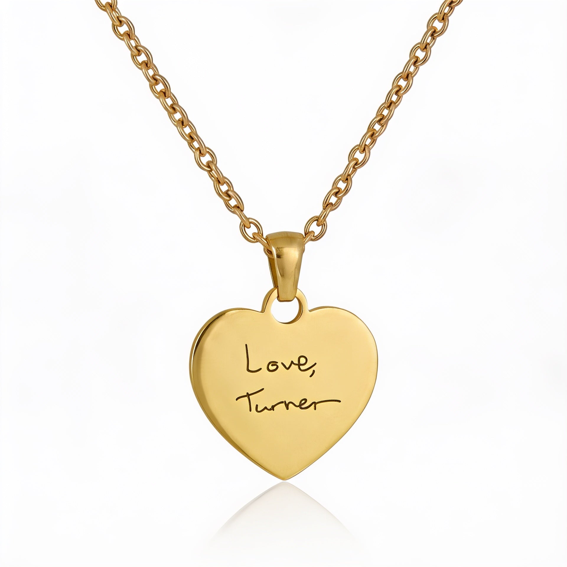 Gold heart-shaped pendant with engraved text on a white background