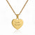 Gold heart-shaped pendant with engraved text on a white background