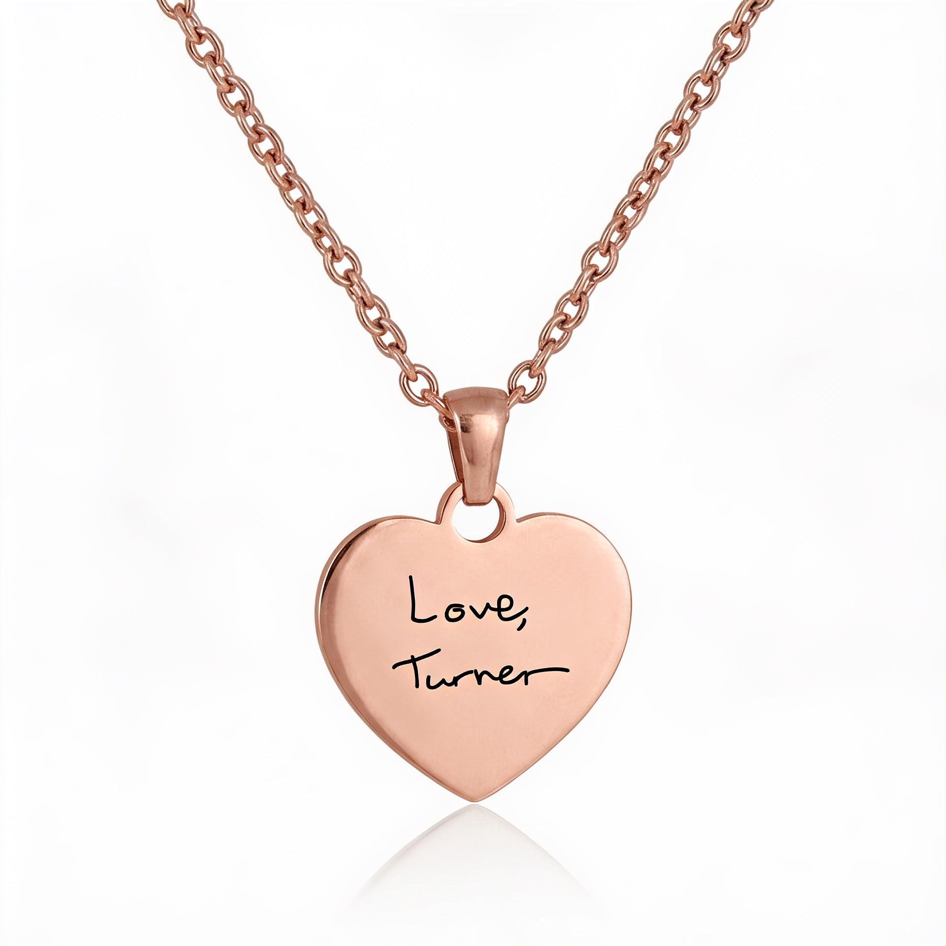 Rose gold heart-shaped pendant with 'Love Turner' engraving on a white background
