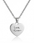 Silver heart-shaped pendant necklace with 'Love Turner' engraving on a white background