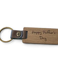 Wooden keychain with 'Happy Father's Day' engraving on a white background