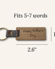 Wooden keychain with leather accent and engraved text, shown with measurements on a white background.